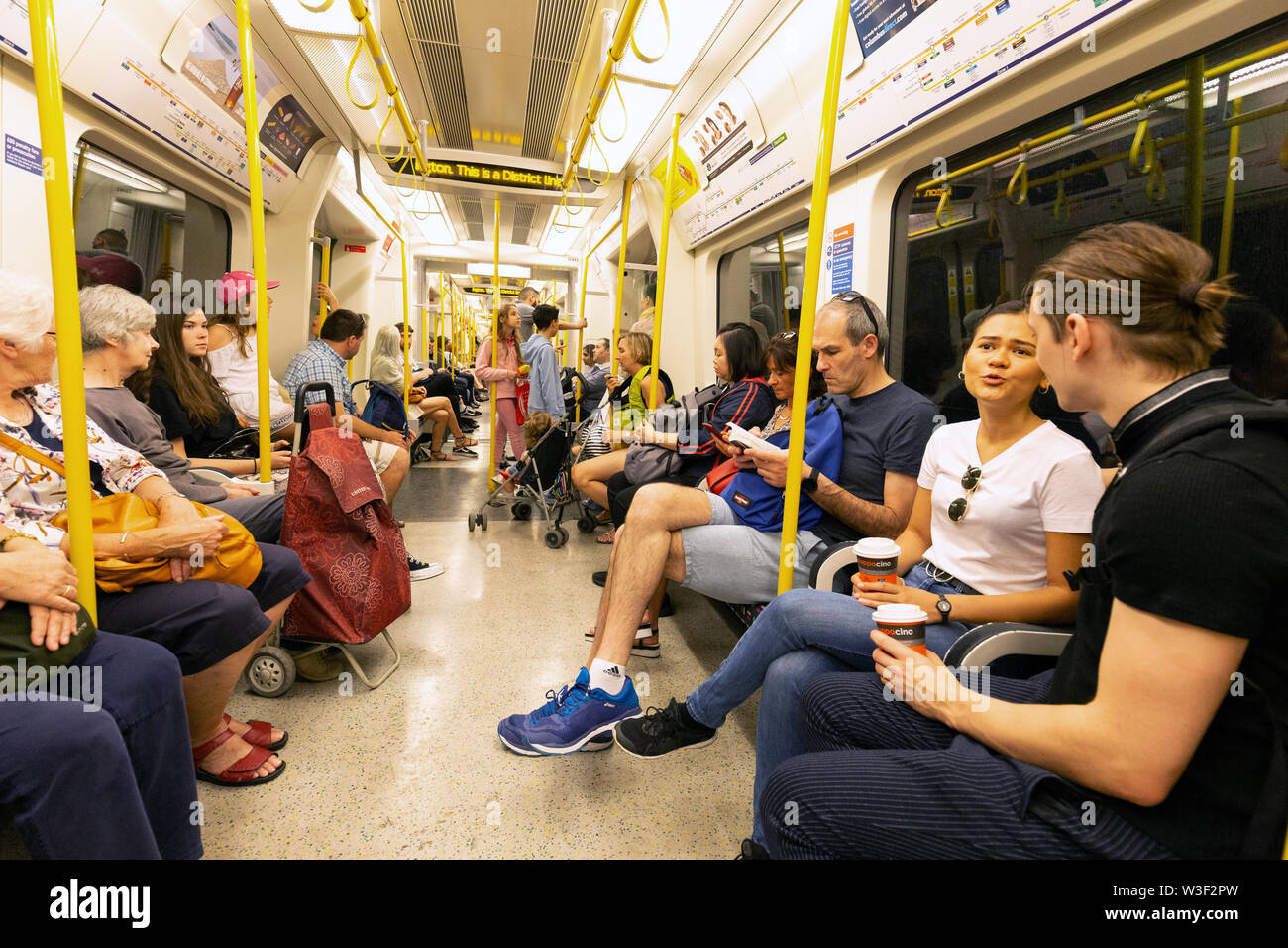 Londoner U-Bahn-Innenraum; Passagiere sitzen in der Beförderung einer Circle Line London U-Bahn, London UK Stockfoto