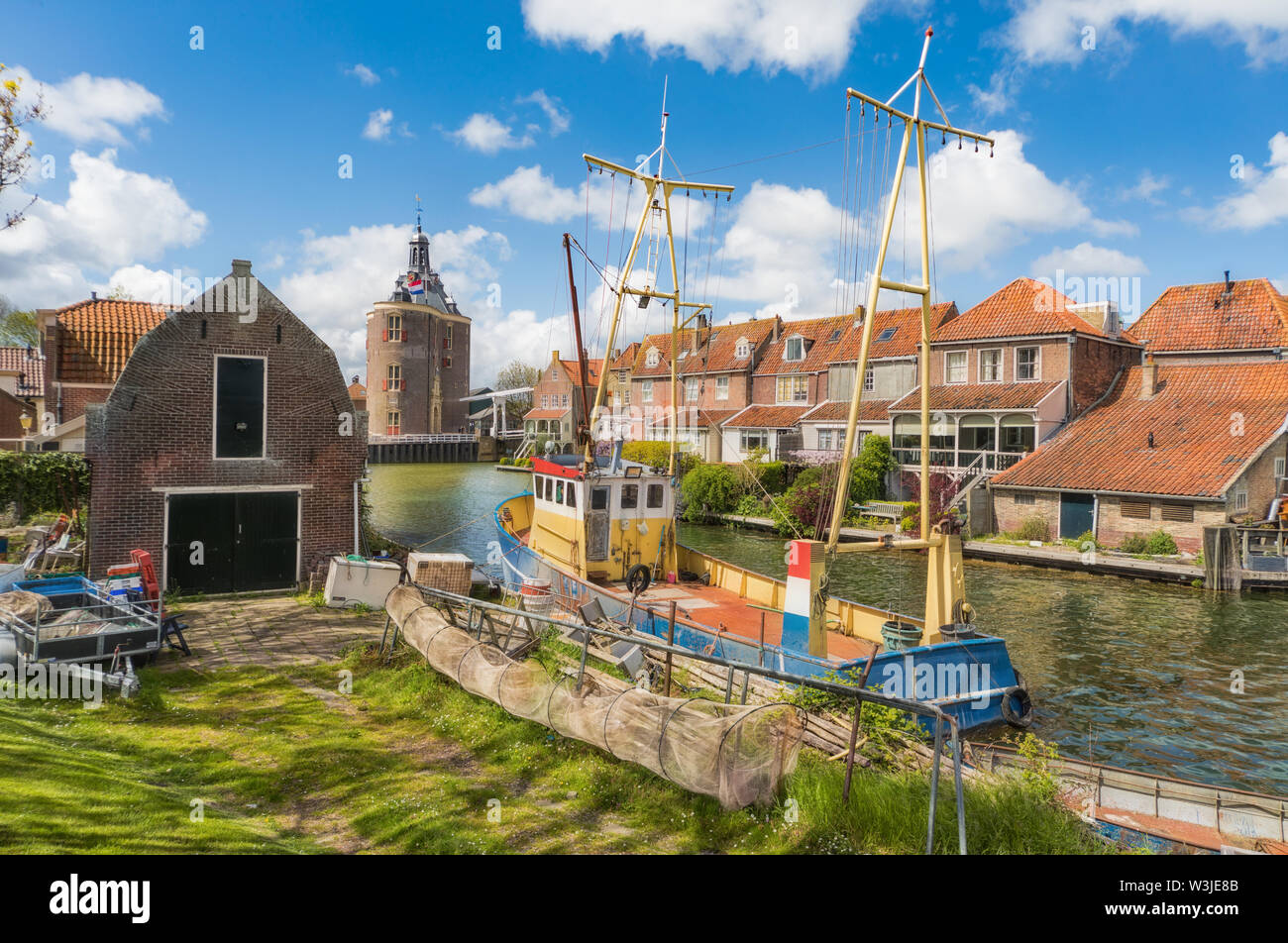 Fischerboot in Enkhuizen in den Niederlanden mit dem historischen Stadttor (Drommedaris) im Hintergrund. Stockfoto