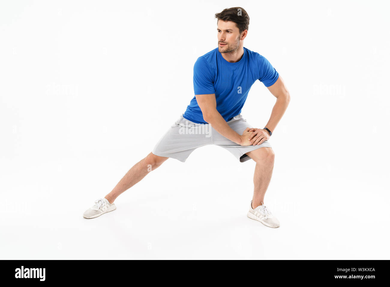 Foto der jungen athletischen Mann in Shorts und T-Shirt, sportliche Übungen während der Arbeit aus isoliert auf weißem Hintergrund Stockfoto
