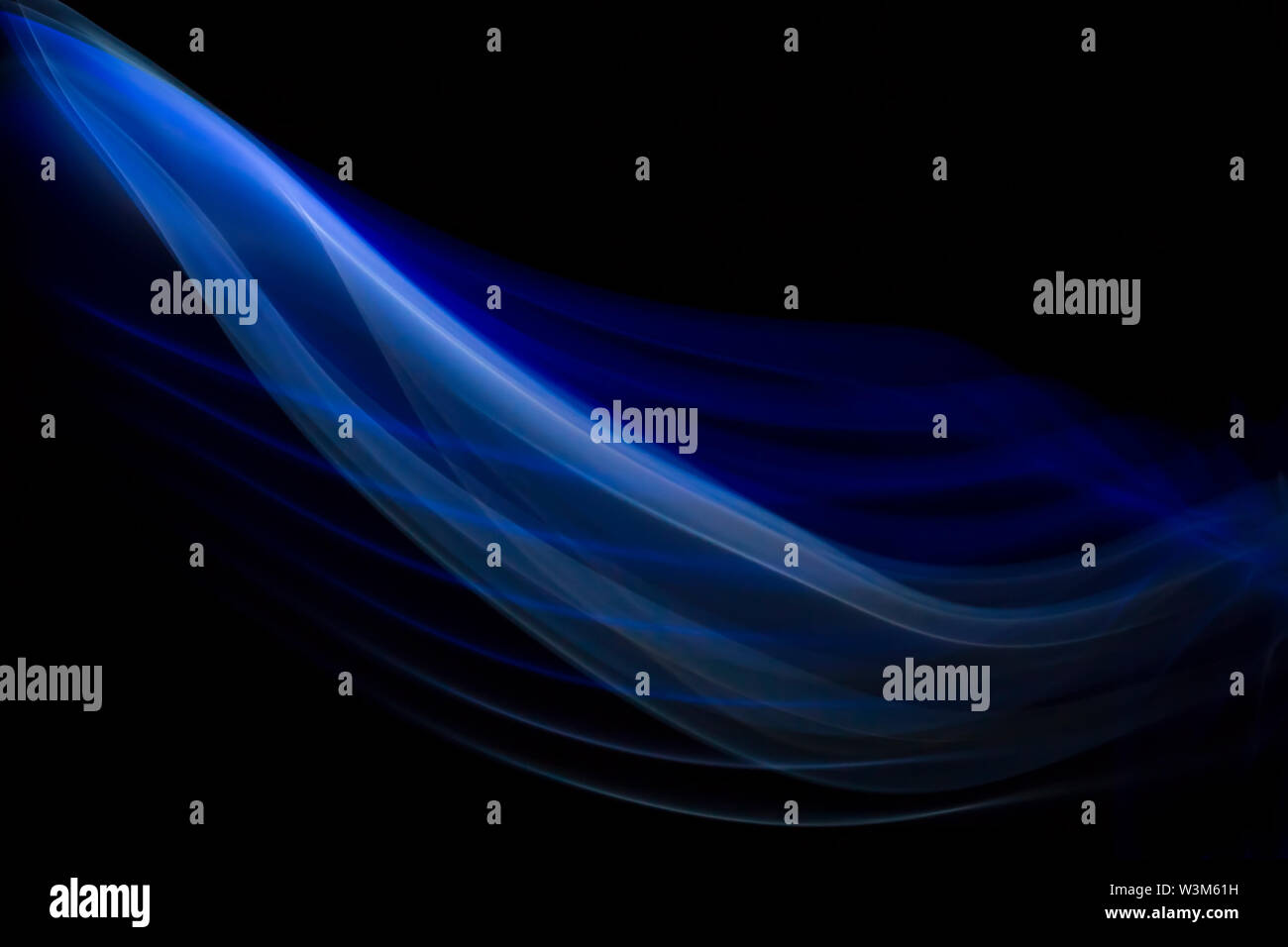 Close up bunt Blau und Weiß hinterleuchtete Spuren von Rauch und Nebel erzeugen System der abstrakten Kurven und Linien auf schwarzem Hintergrund isoliert. Kreativ. Stockfoto