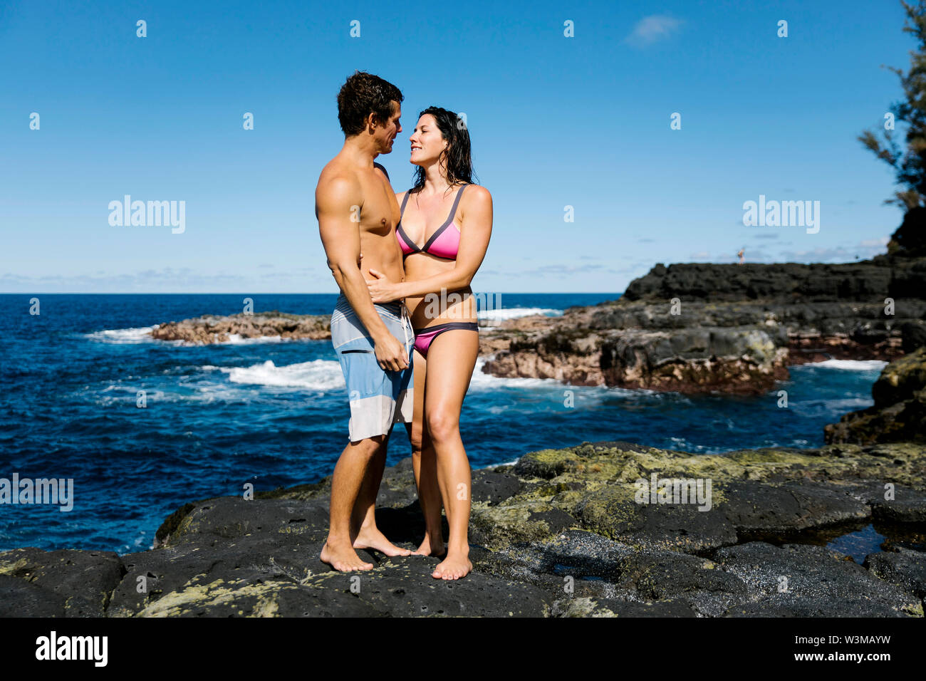 Paar umarmend auf den Felsen, auf dem Seeweg Stockfoto