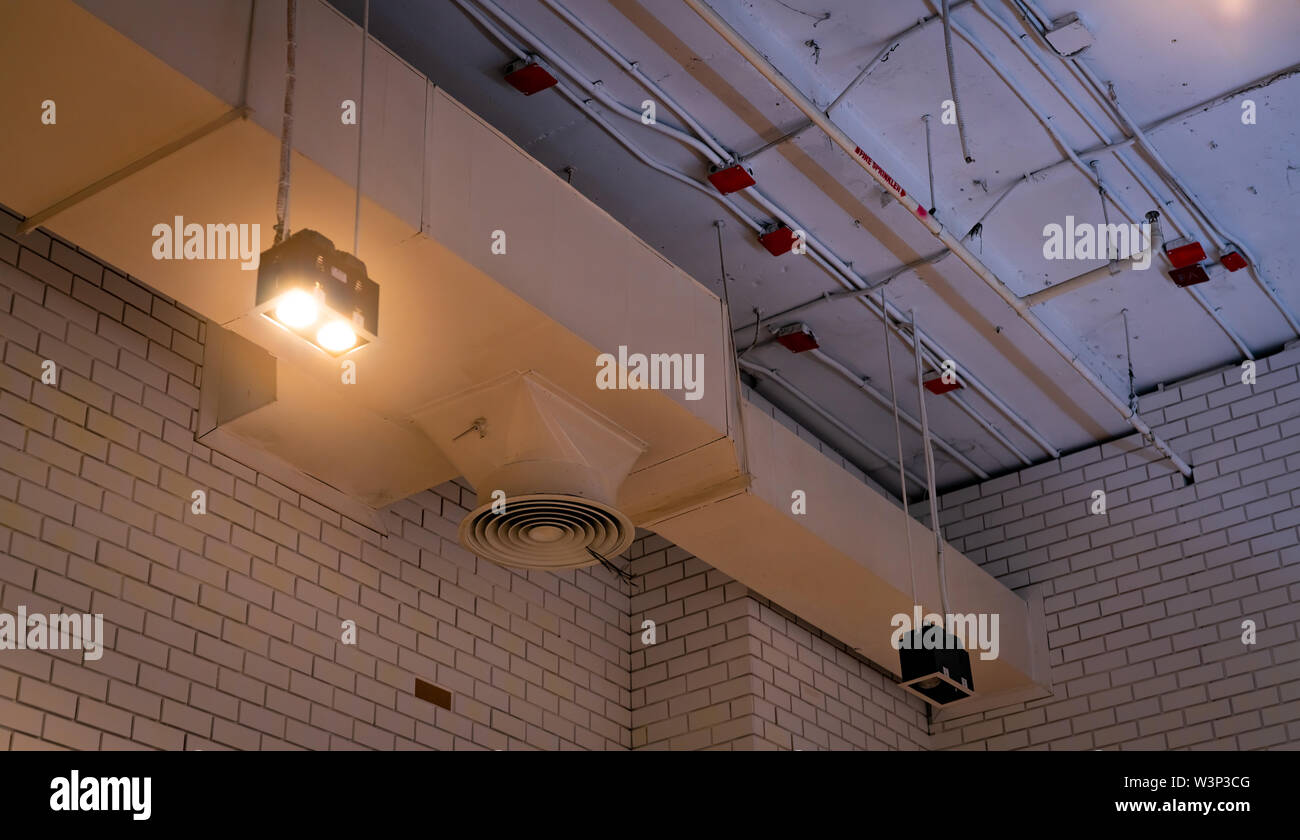 Deckenleuchte mit eröffnet Licht und Luftkanal hängt an der Decke. Klimaanlage Rohrsystem. Belüftungssystem. Fire Sprinkler. Cool System Stockfoto