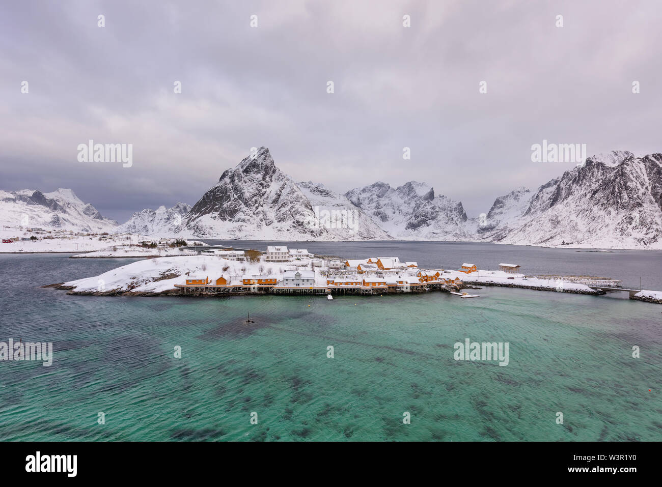 Typisch norwegische Landschaft. Wunderschöne Aussicht auf malerische Lofoten Winter Landschaft mit traditionellen gelben fisherman Rorbuer Kabinen in der historischen Stockfoto