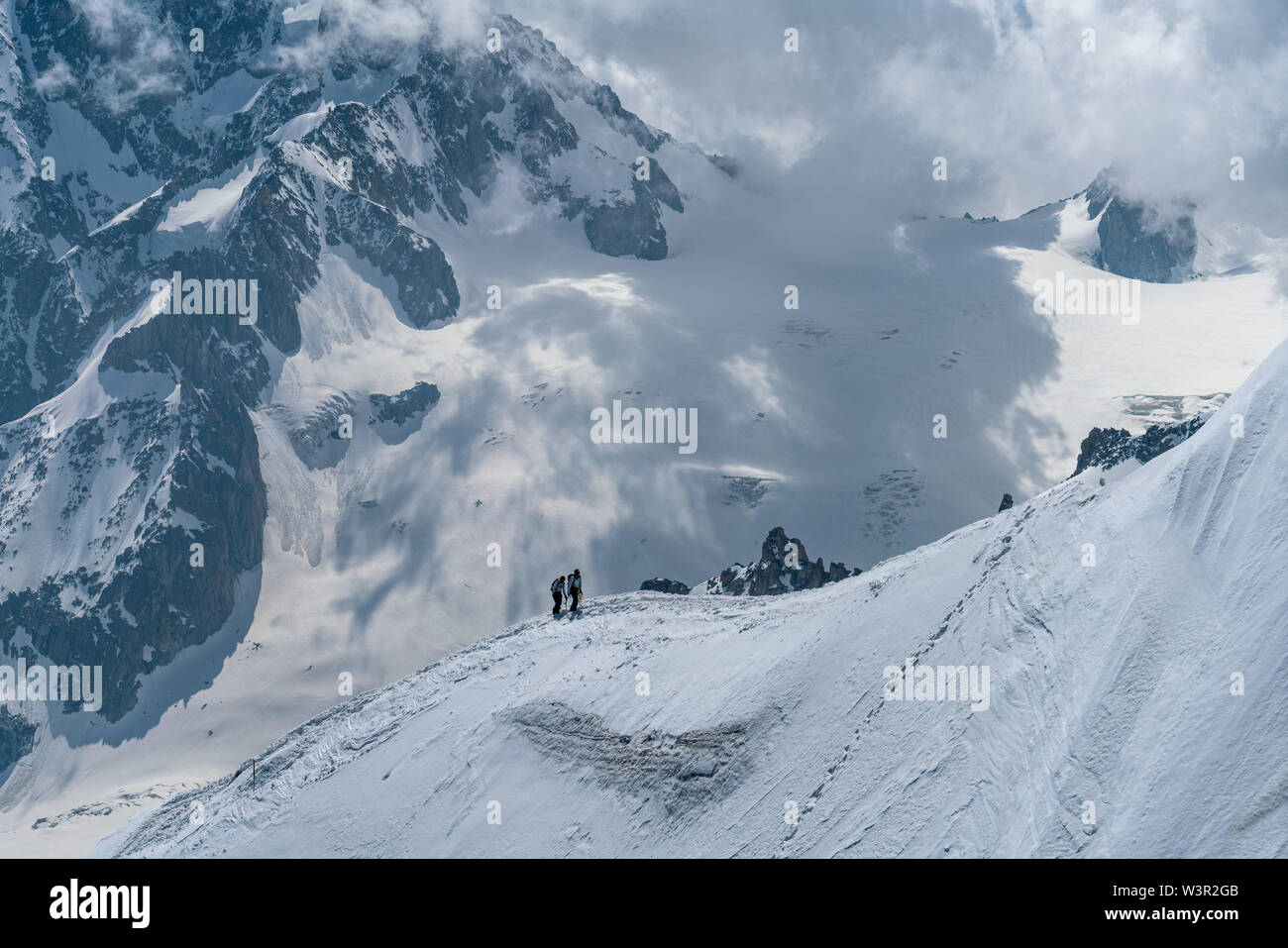 Alpinist der Rückkehr zur Aiguille du Midi von Mont-Blanc mit riesigen Berg Hintergrund in Chamonix, Frankreich Stockfoto