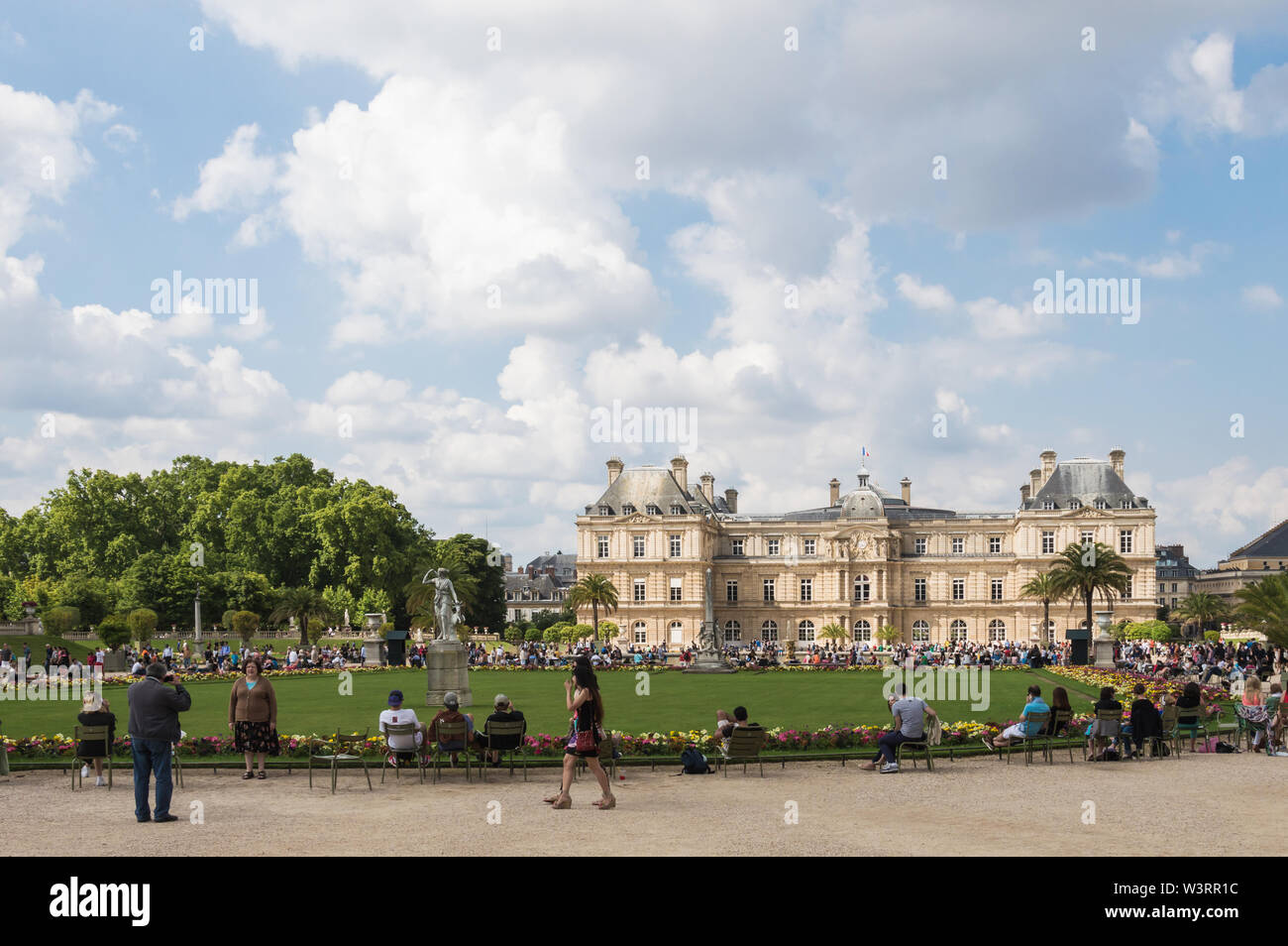 Paris - 13. Juli 2014: horizontale Ansicht von Luxemburg Gardens und Palace überfüllt mit Touristen an einem bewölkten Sommertag Stockfoto