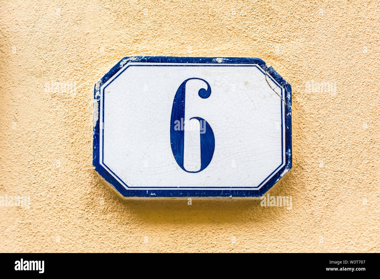 Haus Nummer sechs, 6 (6) Auf einem Putz an der Wand Stockfoto