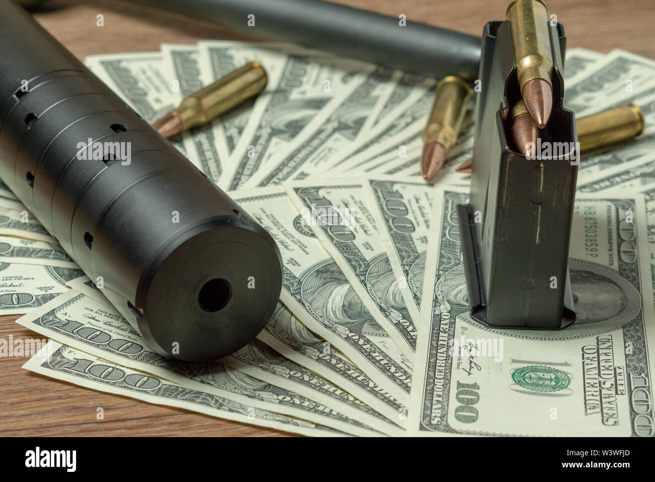 Rifle barrel, Unterdrücker und Patronen auf den Dollar. Konzept für Kriminalität, Mord, Mörder, Terrorismus, Krieg, globalen Waffenhandel, Waffen Stockfoto