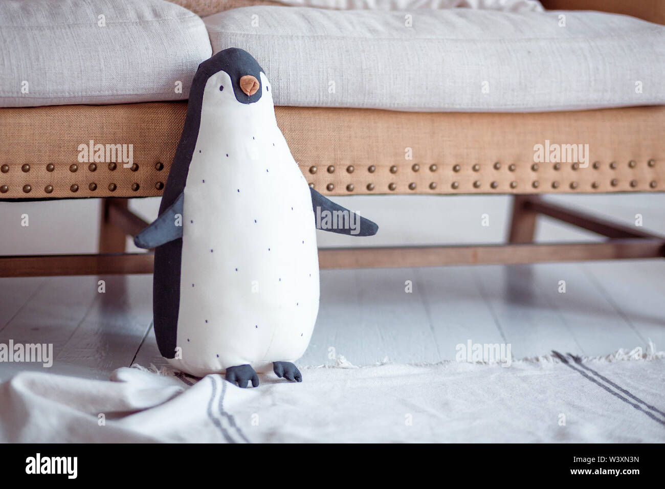 Soft Toy big steht in der Nähe der Sofa auf dem Boden Stockfoto