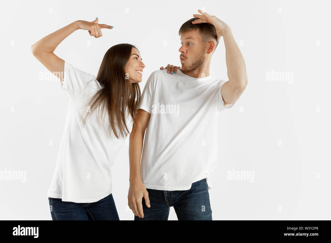 Die schöne junge Paar portrait Studio isoliert auf weißem Hintergrund. Mimik, menschliche Gefühle, Werbung Konzept. Copyspace. Frau und Mann tanzen und lächelnd, cooler Look. Stockfoto