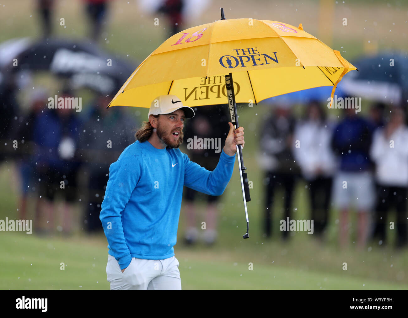 England's Tommy Fleetwood unter einem Regenschirm am 17. Tag eines der Open Championship 2019 im Royal Portrush Golf Club. Stockfoto