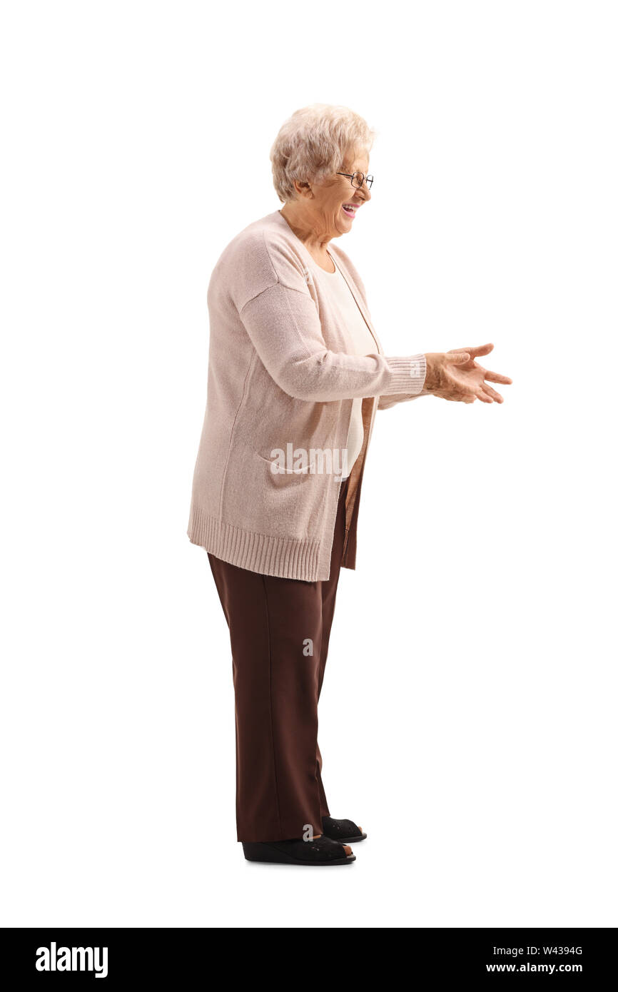 Volle Länge geschossen von einer älteren Frau warten etwas isoliert auf weißem Hintergrund zu erhalten Stockfoto