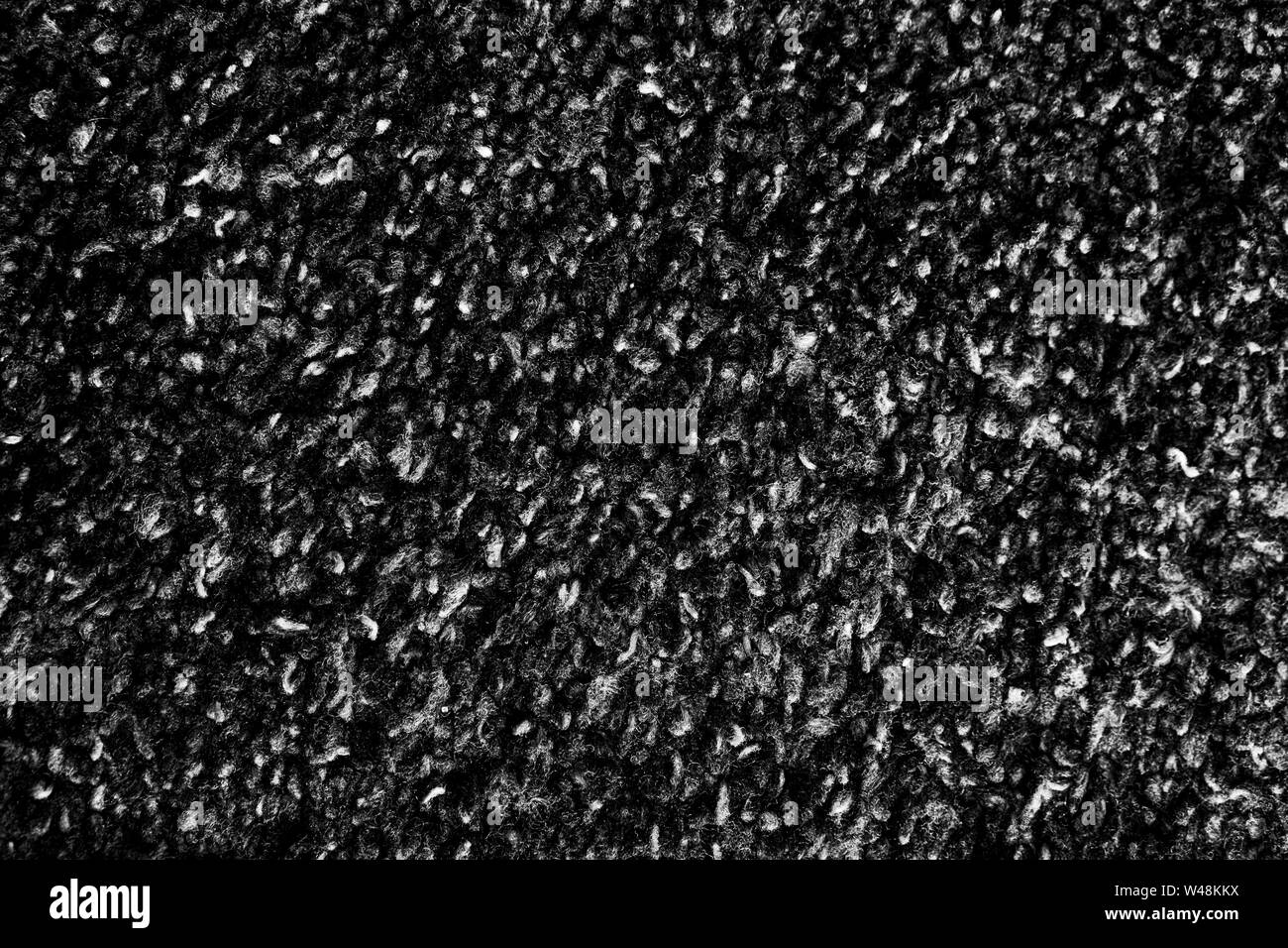 Grobe schwarzer Teppich Textur Hintergrund Grafik Asset. Stockfoto