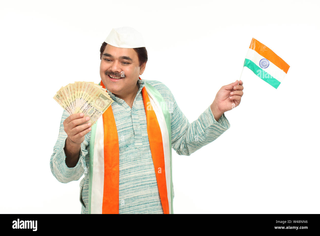 Politiker hält fünfhundert Rupien Banknote mit indischer Flagge Stockfoto