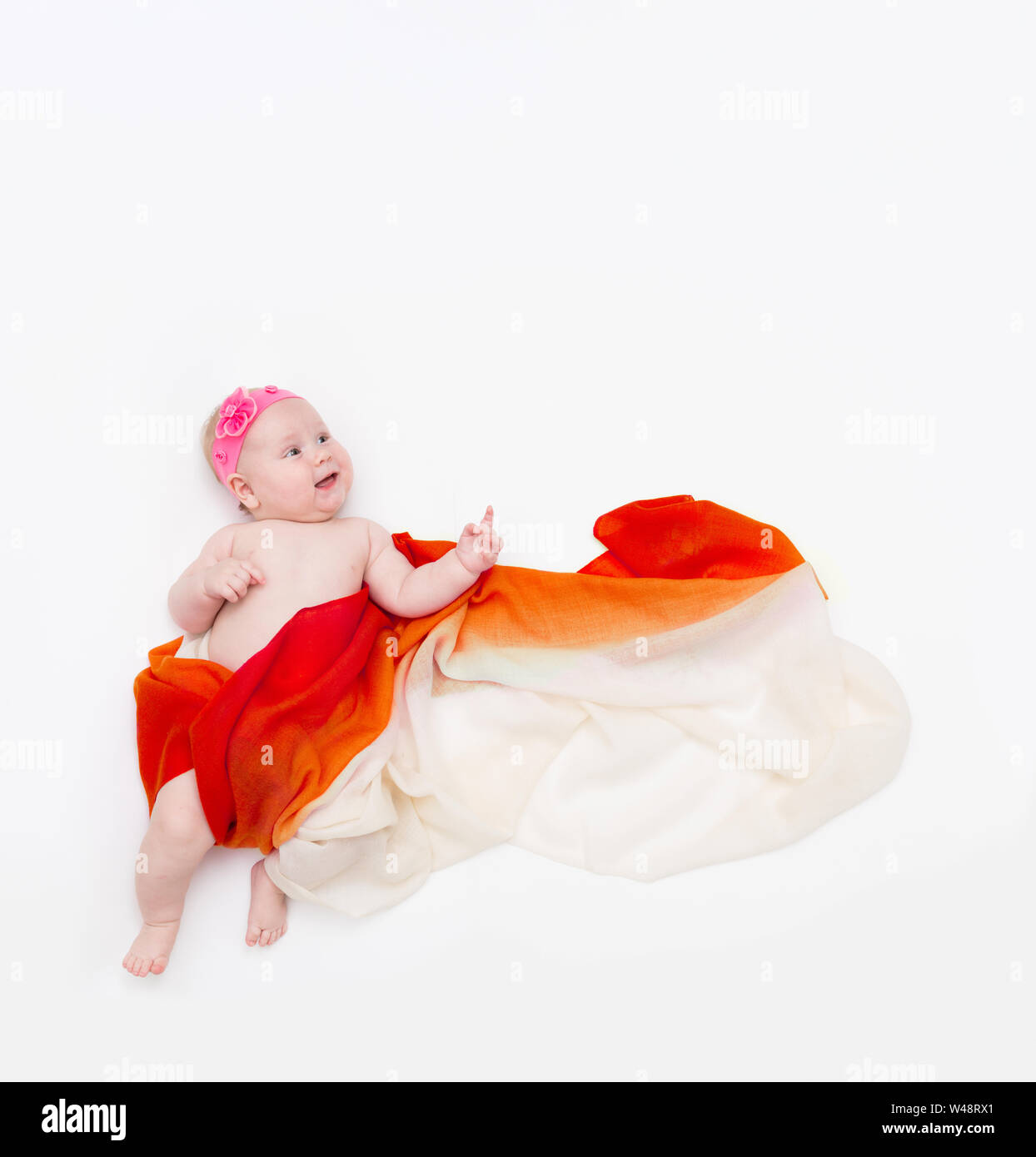 Blick von oben auf die niedlichen Baby Baby gewickelt in einem orangefarbenen Schal nach oben zeigt. Stockfoto