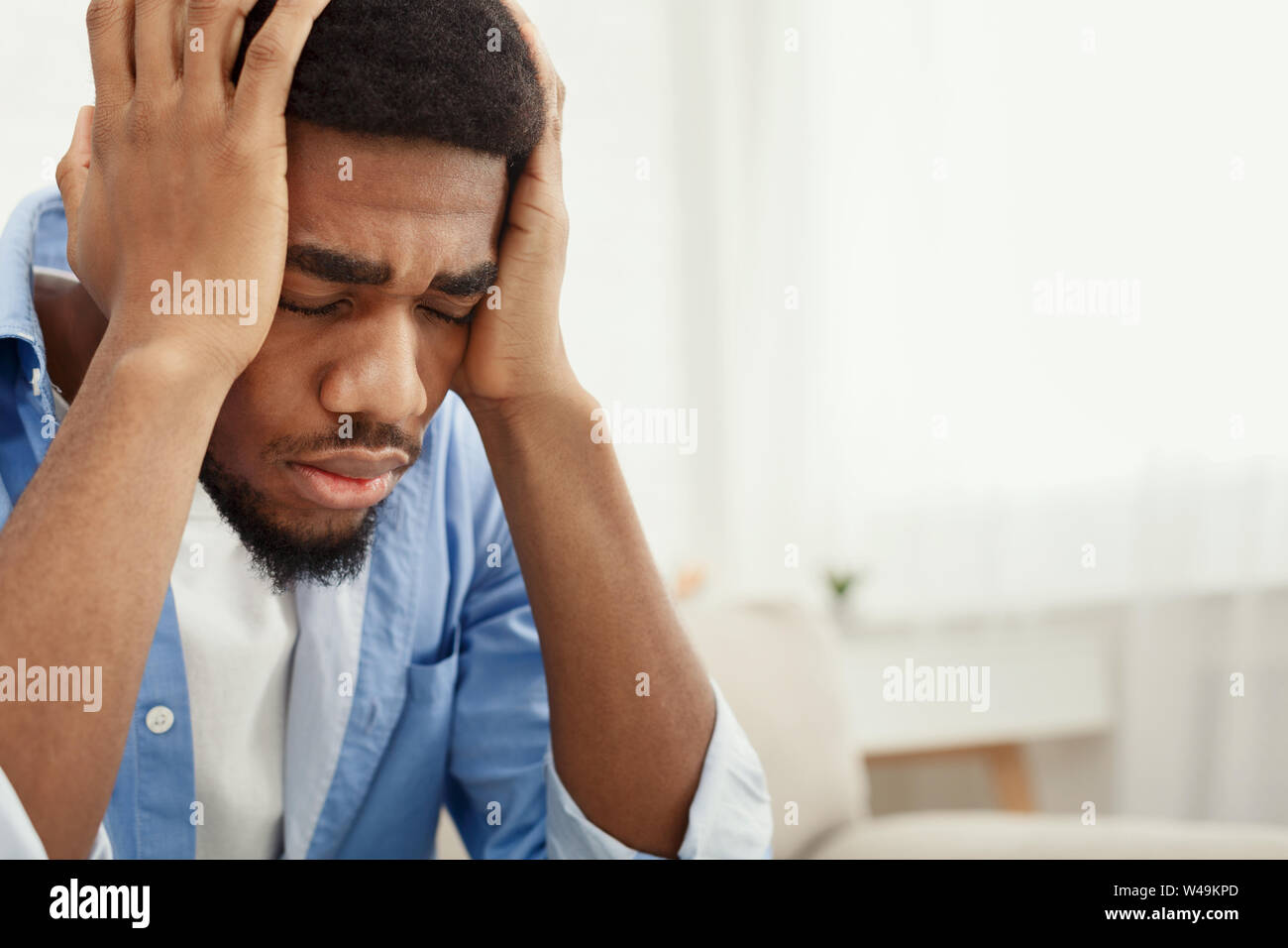 Lonely betätigt man in der Nähe der Fenster zu Hause Stockfoto