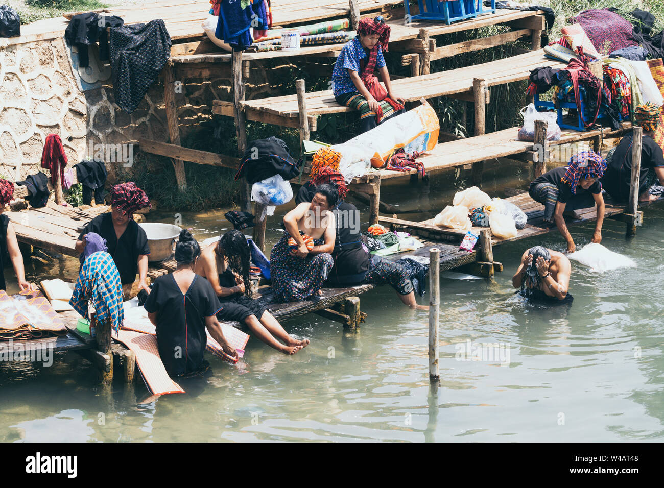 Indein, Myanmar - März 2019: burmesische Frauen aus PaO dragon Menschen Stamm Waschen im Fluss zum Inle See. Stockfoto