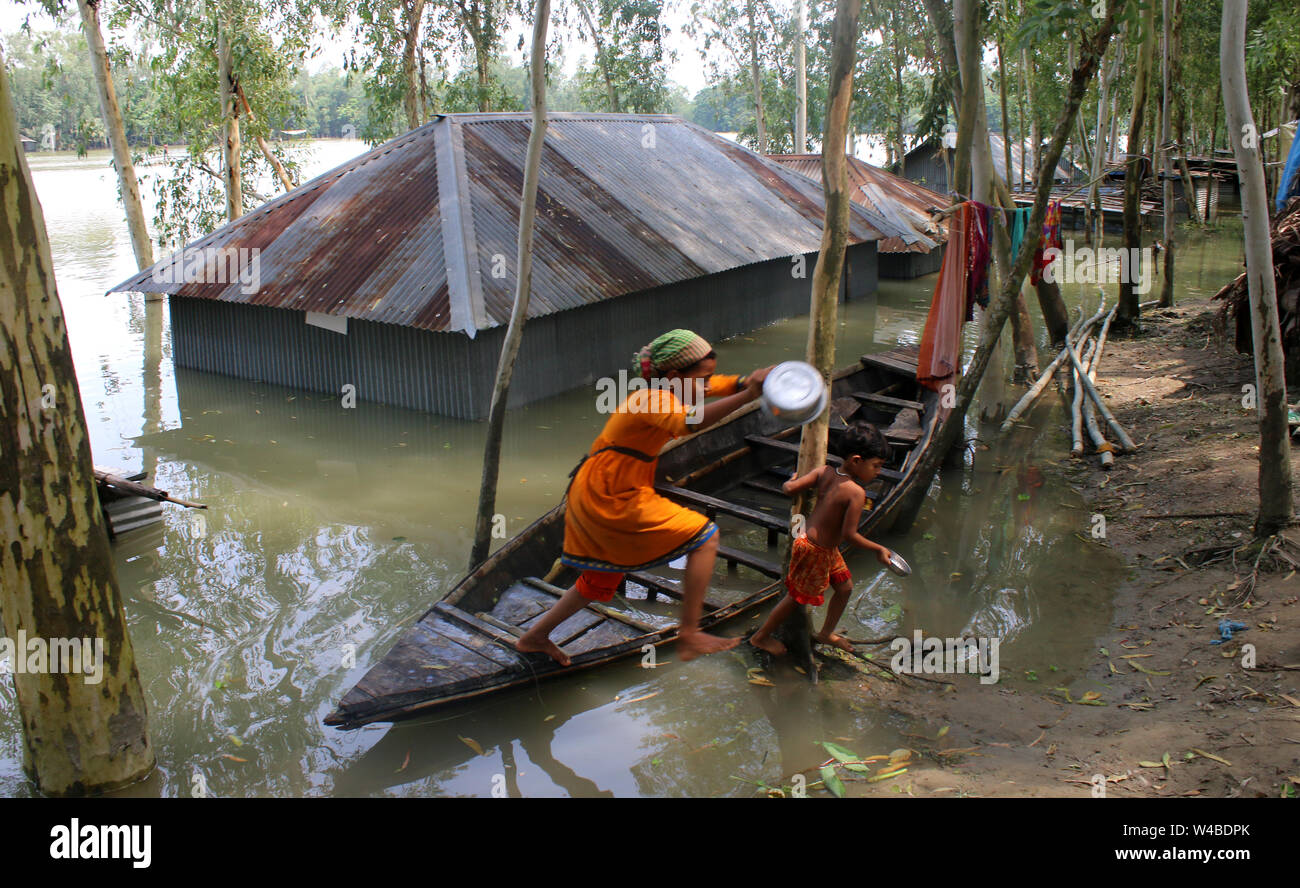 Tangail, Bangladesch. 21. Juli, 2019. Die Menschen nehmen Tierheim neben der Straße nach schweren Monsunregen zu einem Hochwasser betroffene Fläche in Tangail. Über millionen Menschen durch Überschwemmungen durch den Monsun Regen und ausufernden Fluss im Norden, Nordosten und hügeligen Regionen in Bangladesch ausgelöst betroffen. Credit: SOPA Images Limited/Alamy leben Nachrichten Stockfoto