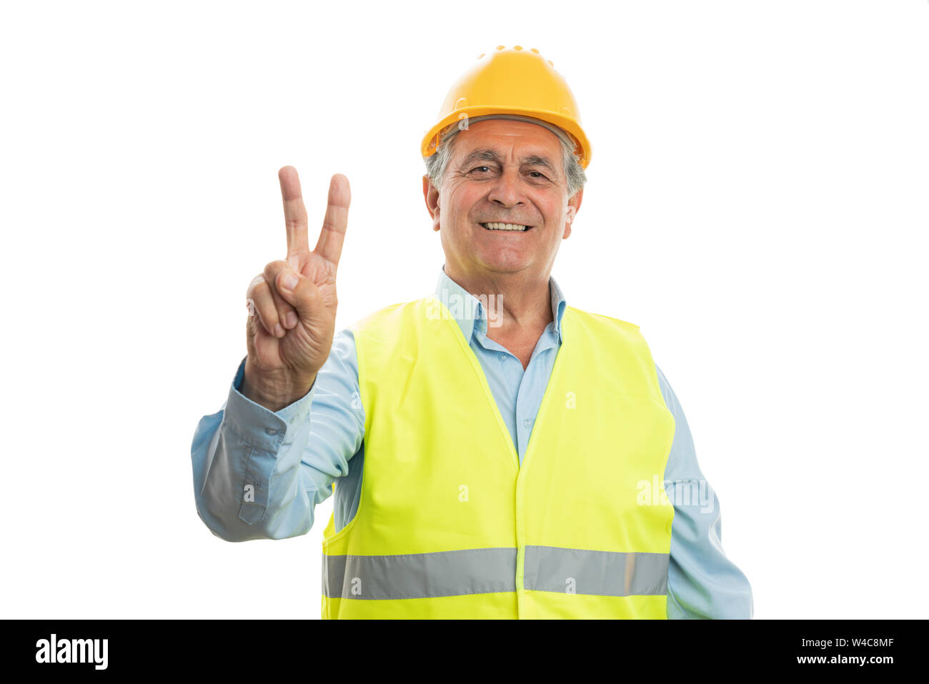 Alten männlichen Builder übersicht Sieg oder Frieden mit Zeige- und Mittelfinger isoliert auf weißem Stockfoto