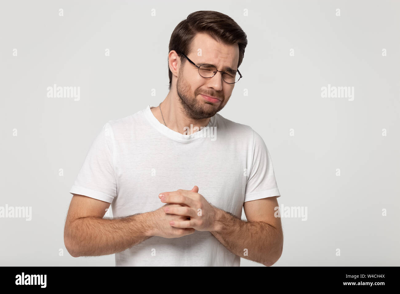 Weeper Kerl geschlossenen Augen jammert auf Grau studio Hintergrund isoliert Stockfoto