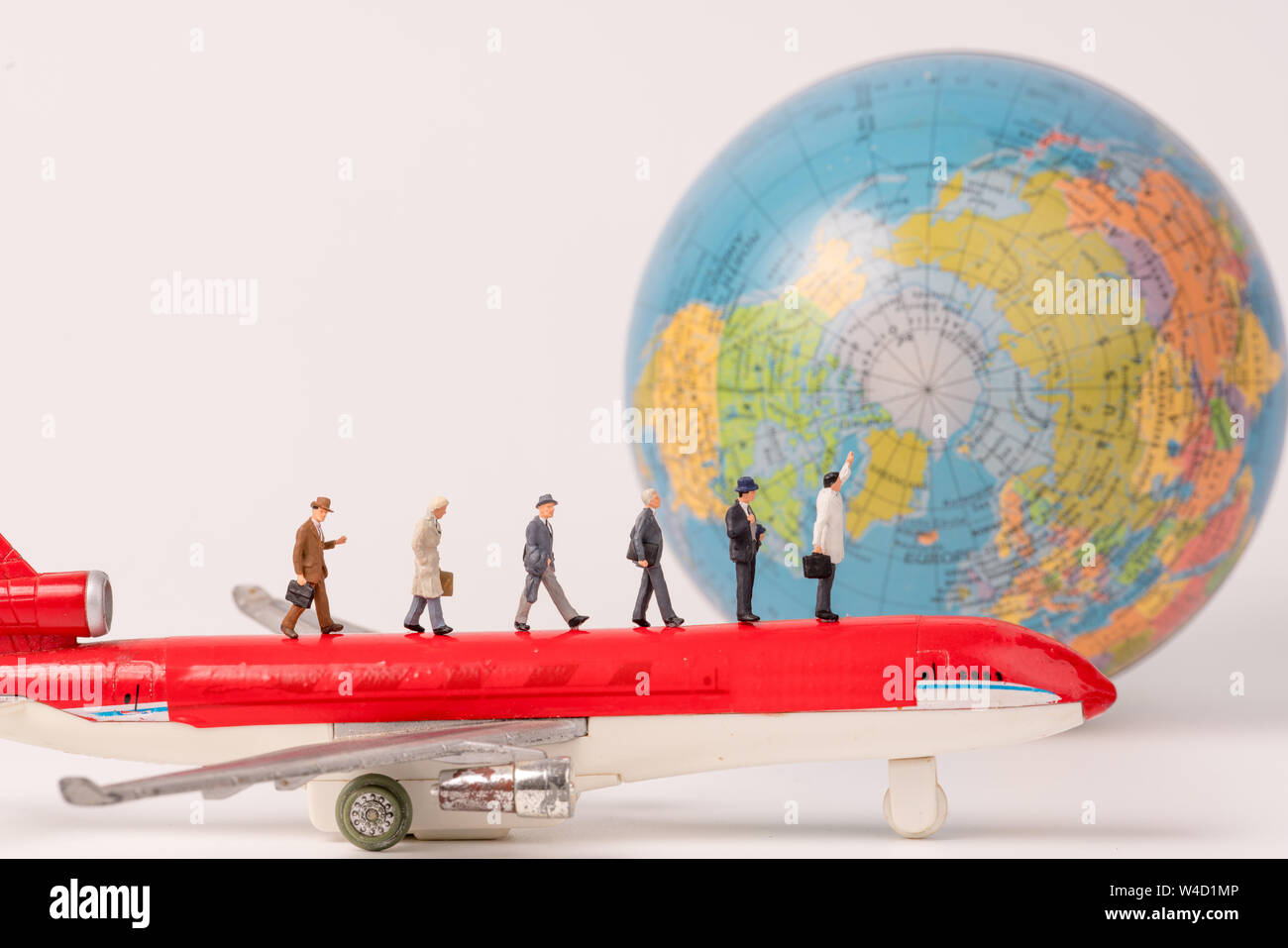 Minifigürchen von Reisenden mit Orb, Flugzeug Hintergrund, Business Konzept Stockfoto