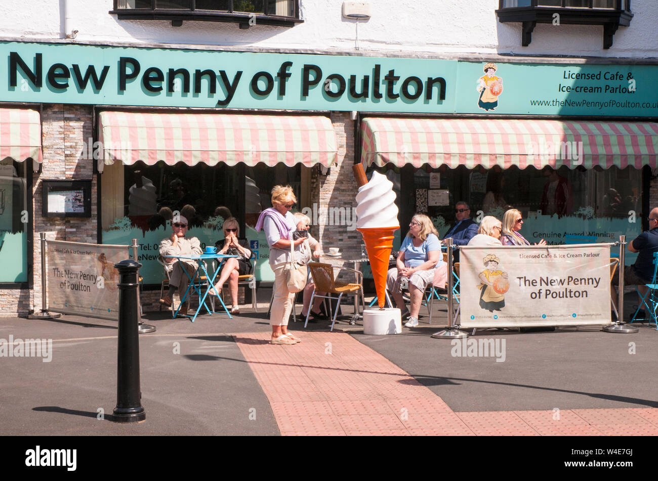 Menschen entspannend durch großes Display Eis an den neuen Penny von Poulton Eisdiele an einem heißen sonnigen Tag in Poulton le Fylde Lancashire England Großbritannien Stockfoto