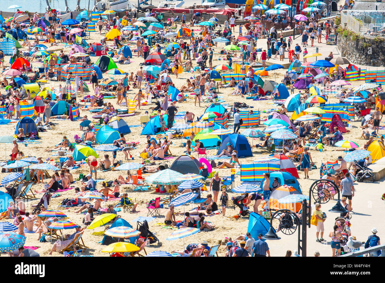 Lyme Regis, Dorset, Großbritannien. 23. Juli 2019. UK Wetter: Massen von Touristen in Scharen zu den malerischen Badeort von Lyme Regis, die glühend heiße Sonne zu genießen und in der ersten Woche der Sommerferien. Urlauber und Familien erfrieren in der heißen Sonne auf gepackten Strand der Stadt, während andere ein erfrischendes Bad im Meer auf, was die heißeste Woche des Jahres zu sein, so weit wie die afrikanischen Plume hits südlichen Großbritannien eingestellt ist. Credit: Celia McMahon/Alamy Leben Nachrichten. Stockfoto