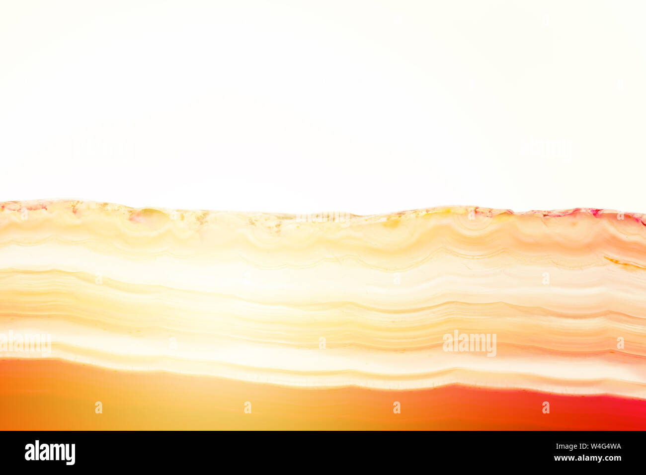 Zusammenfassung Hintergrund, rot und orange Achat mineral Querschnitt mit Sunbeam auf weißem Hintergrund gestreift Stockfoto