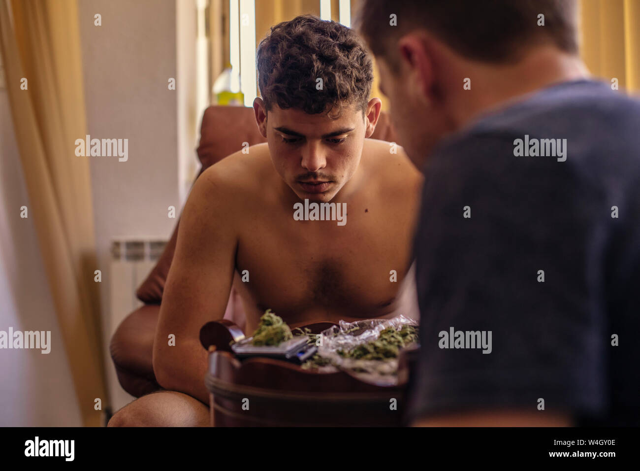 Zwei junge Männer in Livving Zimmer im Marihuana Knospen suchen Stockfoto