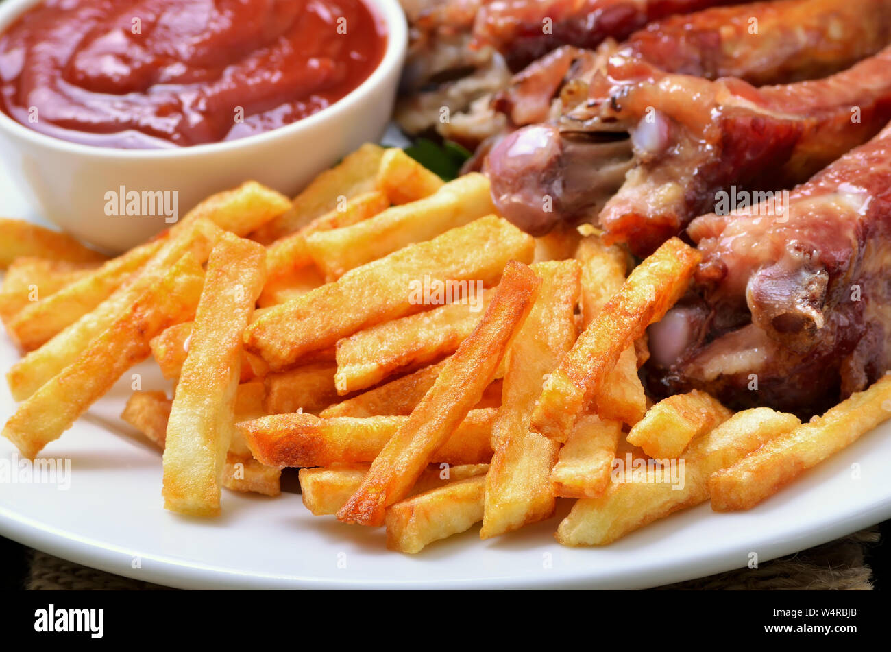 Bratkartoffeln, Rippchen und Tomatensauce, Ansicht schließen Stockfoto