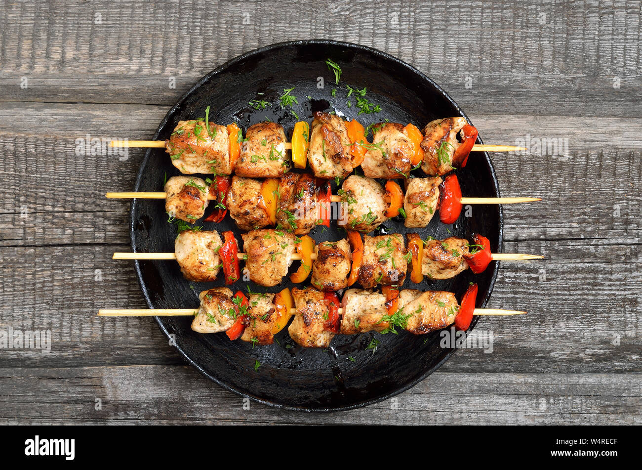 Gegrilltes Hühnchen Kebab mit Gemüse auf Holztisch, Ansicht von oben Stockfoto