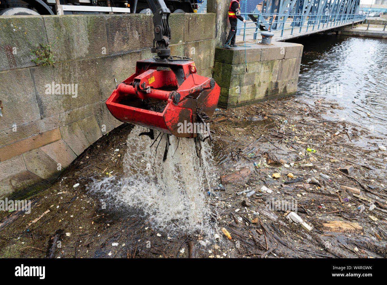 Reinigung von Ablagerungen an der Brücke gesammelt auf dem Wasser von Leith Fluss in Leith nach starken Regenfällen, Schottland, Großbritannien Stockfoto