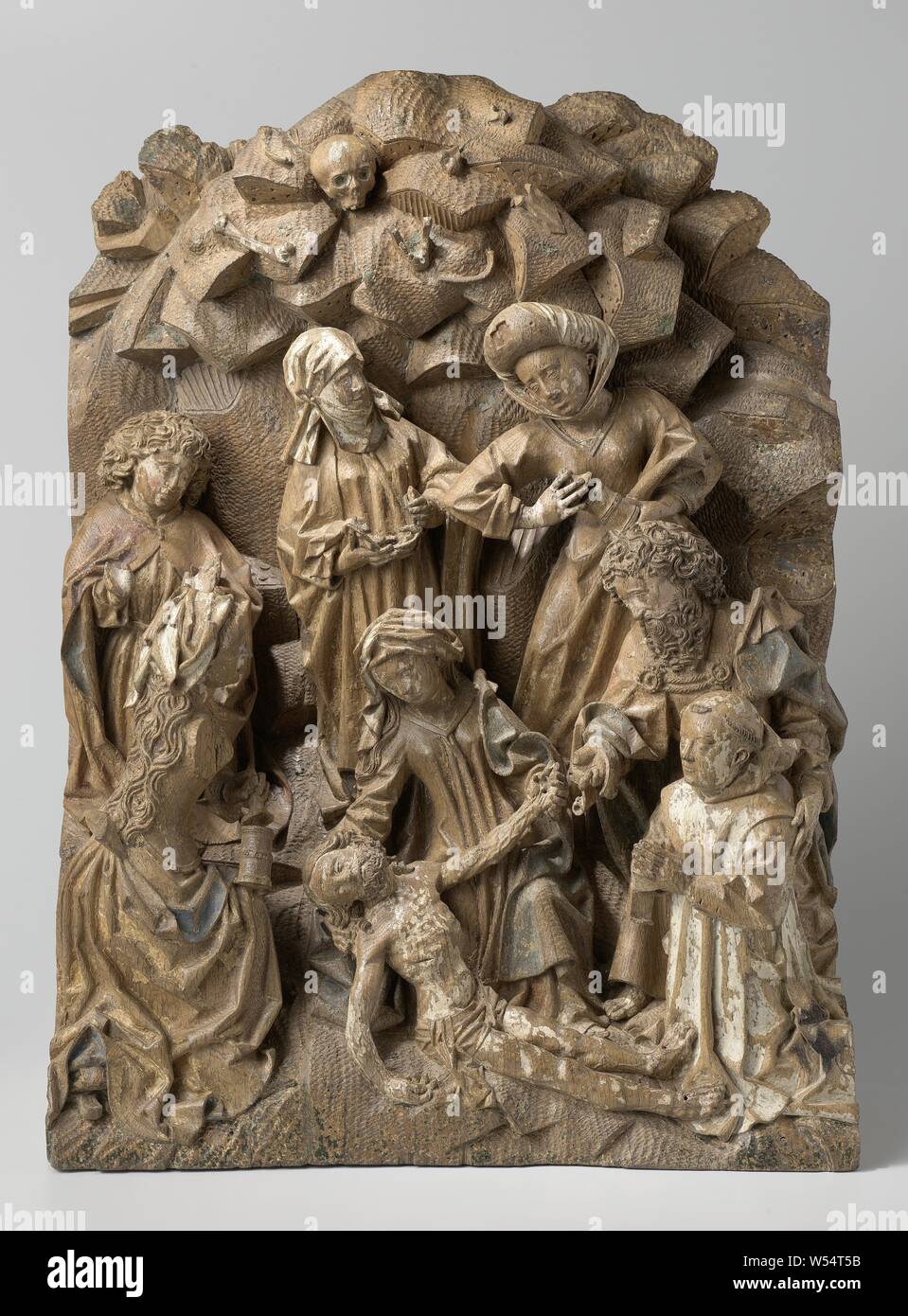 Der Jammer Beweinung Christi mit einer knienden Stifter, am Fuße des Kalvarienbergs Berg aus Felsen, Christus liegt rechts vor der Maria, die Lügen ist auf einem Knie gestreckt. Sie unterstützt Christi Kopf mit der rechten Hand, während die linke Hand mit dem Anderen. Auf der linken Seite, halb zurück, mit einem Knie auf dem Boden, Maria Magdalena wendet sich an Christus, mit dem Halb geöffnete Salbe Kanister zwischen dem linken und dem rechten Knie, hinter ihr, auch kniend, St. Jan mit erhobenen Händen, Handflächen nach außen, seine Emotionen auszudrücken. In Christus die Füße der Gründer kniet im Gebet Stockfoto