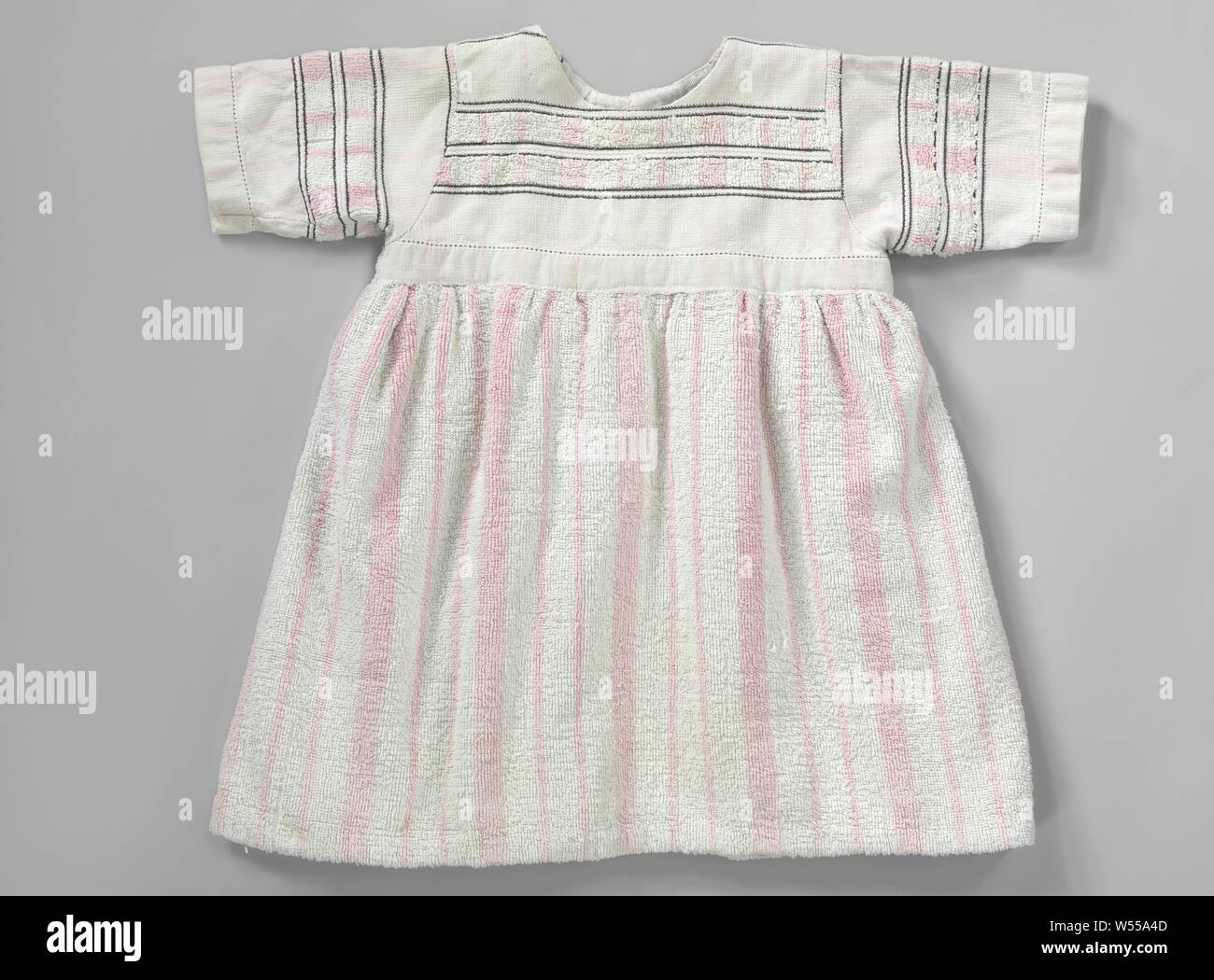 Kinder Kleid mit kurzen Ärmeln, gebildet von einem weiß-rosa gestreifte Frotteehandtuch, auf den Körper mit schwarzen Ziernähten versehen, den Körper mit schwarzen Ziernähten versehen. Modell: Die Prinzessin. Hohe Taille mit faltigen Rock. Kurze Miederweste mit rundem Ausschnitt ohne Kragen und kurzen Ärmeln. Unsichtbare Schließung in den Mittelpunkt rücken. Dekoration: das Handtuch ist so gestaltet, dass die verzierten Rand ist für das Oberteil und die Hülsen verwendet, während der Rock ganz besteht aus den Weiß/Rosa gestreifte terry verarbeitet. Von Henriette Johanna Baruch, Henriette Johanna Baruch, hermína Catharina durchgeführt Stockfoto