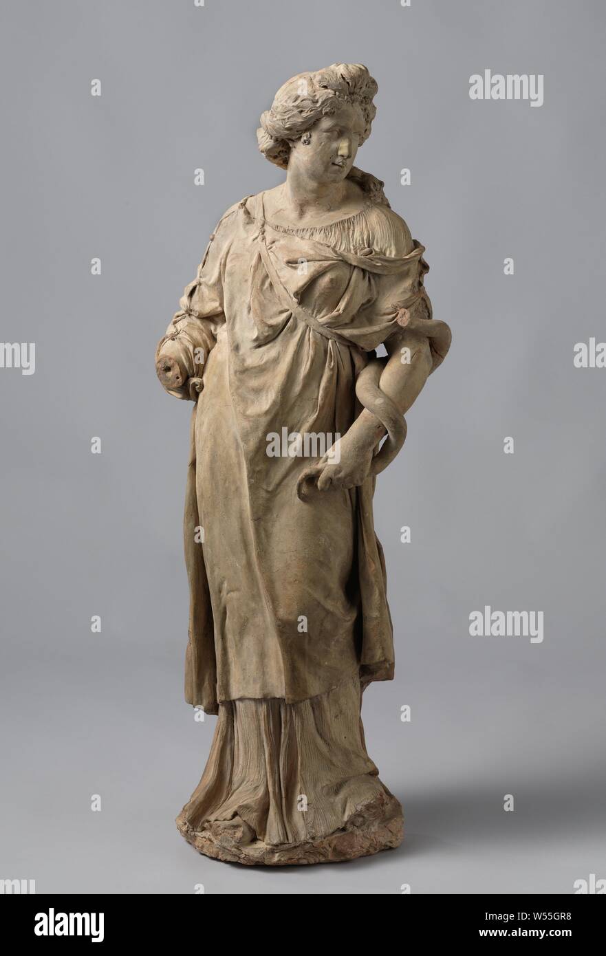 Weisheit, Skizze einer weiblichen Figur mit dem Kopf nach rechts gedreht, stehend auf dem rechten Bein und mit dem linken verbogen. Mit ihrer linken Hand hält sie den Schwanz der Schlange, die Spulen um ihren Arm. Der gewelltes Haar, von denen ein Teil durch eine Perlenkette mit ein Juwel in der Front gehalten wird, Tres fällt auf der linken Schulter. Zusätzlich zu einem fein plissierten Unterwäsche, sie trägt eine Jacke mit Ärmeln, die Dias aus der linken Schulter und ist zusammen mit dem Riemen über der Brust laufen statt. Die Ärmel zeigt einen kontinuierlichen, geschlossen Knopfverschluss. Rückseite fast flach und unverarbeitete Stockfoto