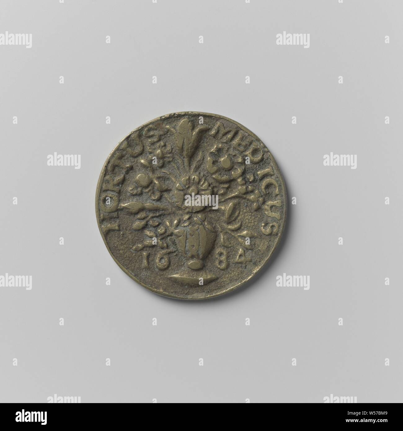 Collegium Medicum in Amsterdam, Access Token für den Hortus Medicus für Apotheker Lehrling J.J.L, Messing Token, Vz: Vase mit Blumen zwischen den Jahren, auf Vase: Wappen in einer Inschrift. Rückwärtsgang: Monogramm Buchstaben J, J und L über Vorjahr, Amsterdam, Hortus Medicus, anonym, 1779, Messing (Legierung), Gründung, d 2,9 cm × w 8.26 Stockfoto