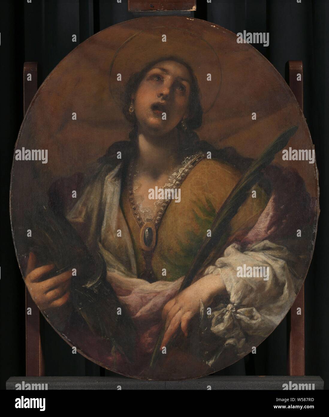 Die hl. Katharina, die hl. Katharina. Hälfte - Abbildung in Oval, Mund und Augen. In den Händen ein Stück der Rad und einem Palm Zweig, die Jungfrau und Märtyrerin Katharina von Alexandria, mögliche Attribute: Buch, Krone, Kaiser Maxentius, Ast, Ring, Schwert, Rad, Francesco Montelatici, 1617-1661, Panel, Ölfarbe (Lack), h 81,5 cm x W 69 cm d 7 cm Stockfoto