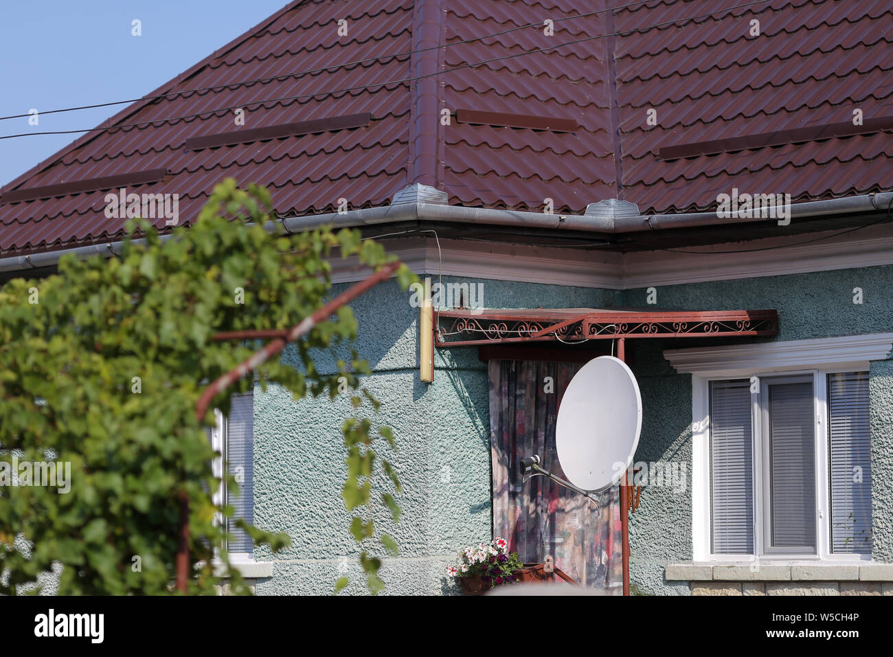 Fernseher Satelliten Receiver Antenne auf ein Haus in einem Dorf in ländlichen Rumänien Stockfoto