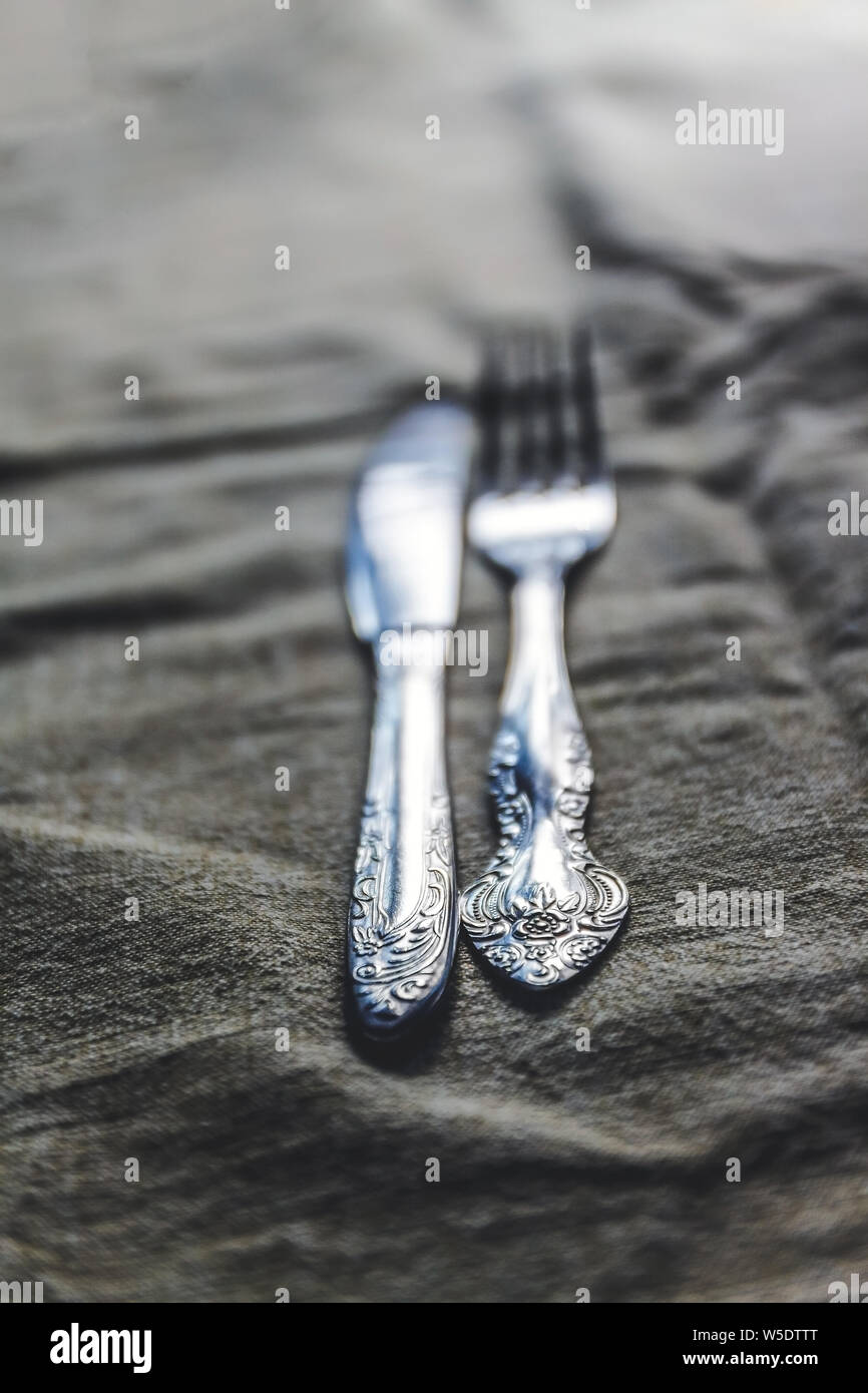 Retro Vintage Besteck Messer und Gabel auf antiken Tischdecke. Stockfoto