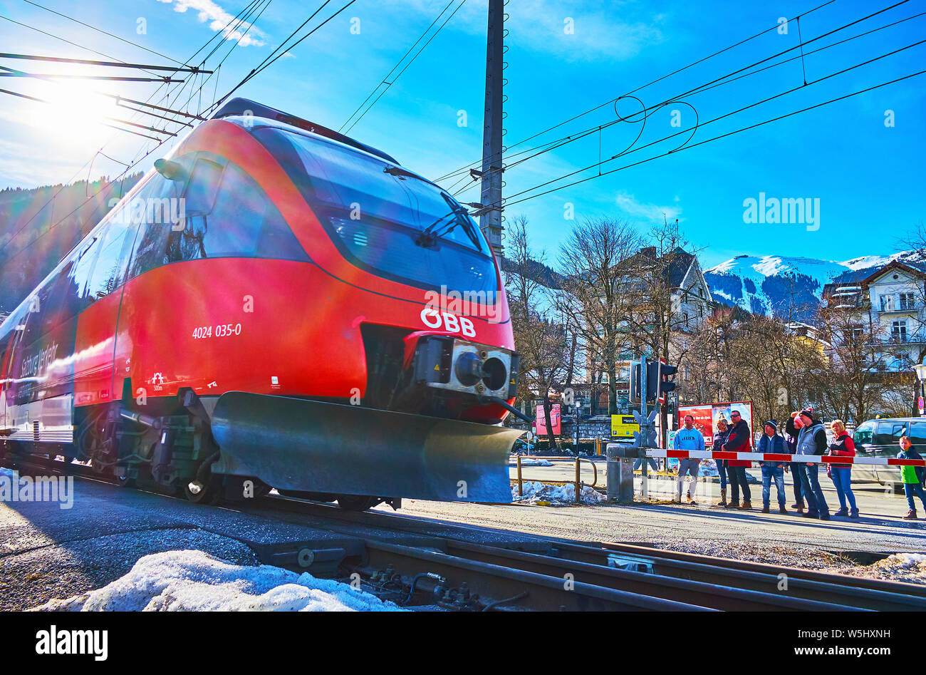 ZELL AM SEE, Österreich - 28. FEBRUAR 2019: Die modernen roten Zug fährt die Zebrastreifen in der Altstadt, am 28. Februar in Zell am See Stockfoto