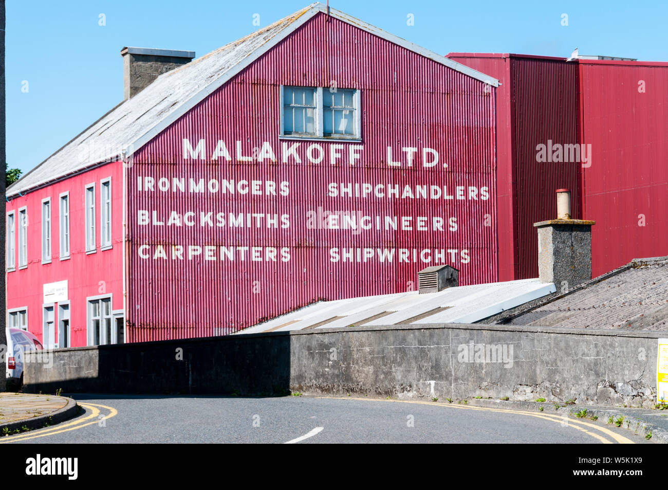 Die rote Wellblech Räumlichkeiten von Malakoff Ltd, Marine- und Bauingenieuren in Lerwick, Shetland. Stockfoto