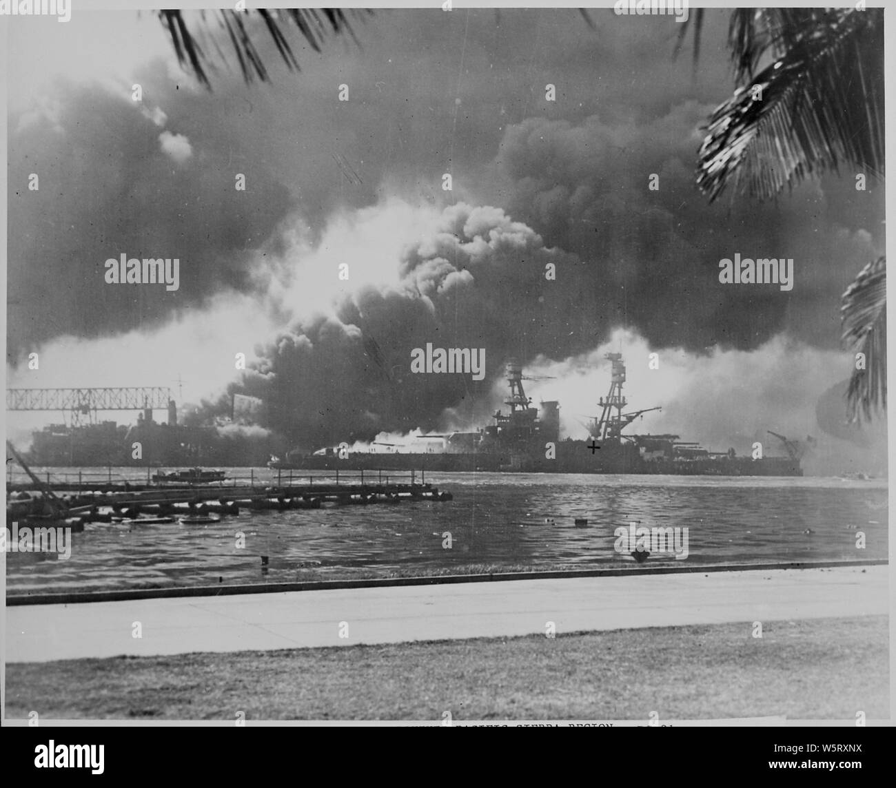 Naval Foto dokumentation der japanische Angriff auf Pearl Harbor, Hawaii, Beteiligung der USA im Zweiten Weltkrieg. Die marine Bildunterschrift: Die Schwelenden Schlachtschiff USS NEVEDA in das Feuer und den Rauch der Zerstörer USS SHAW, die explodierte, als ihr Magazin, das von Bomben von japanischen Flugzeugen während des Angriffs auf Pearl Harbour am 7. Dezember 1941 getroffen wurde.; Umfang und Inhalt: Dieses Foto wurde ursprünglich von einem See Fotograf sofort nach dem japanischen Angriff auf Pearl Harbor, aber kam in einem vollstreckungsbescheid Antrag auf habeas corpus Fall eingereicht werden (Nummer 298) versuchte in den USA Distr Stockfoto