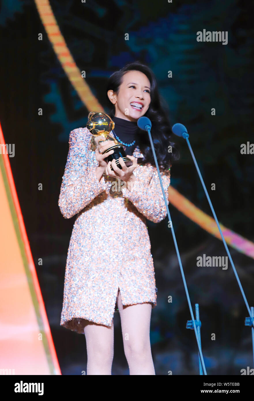 Hong Kong Sängerin und Schauspielerin Karen Mok wirft mit der Trophäe für den 'Most Beliebte Sängerin (Hongkong/Taiwan)' Award am 12. migu Musik Awar Stockfoto