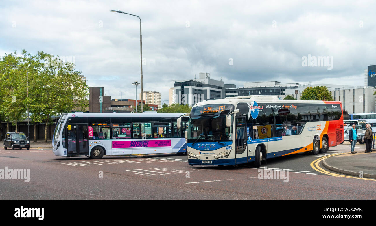 Zwei Eindeckerbusse, Stagecoach und Firstbus, verlassen den Busbahnhof Buchanan im Stadtzentrum von Glasgow, Schottland Stockfoto