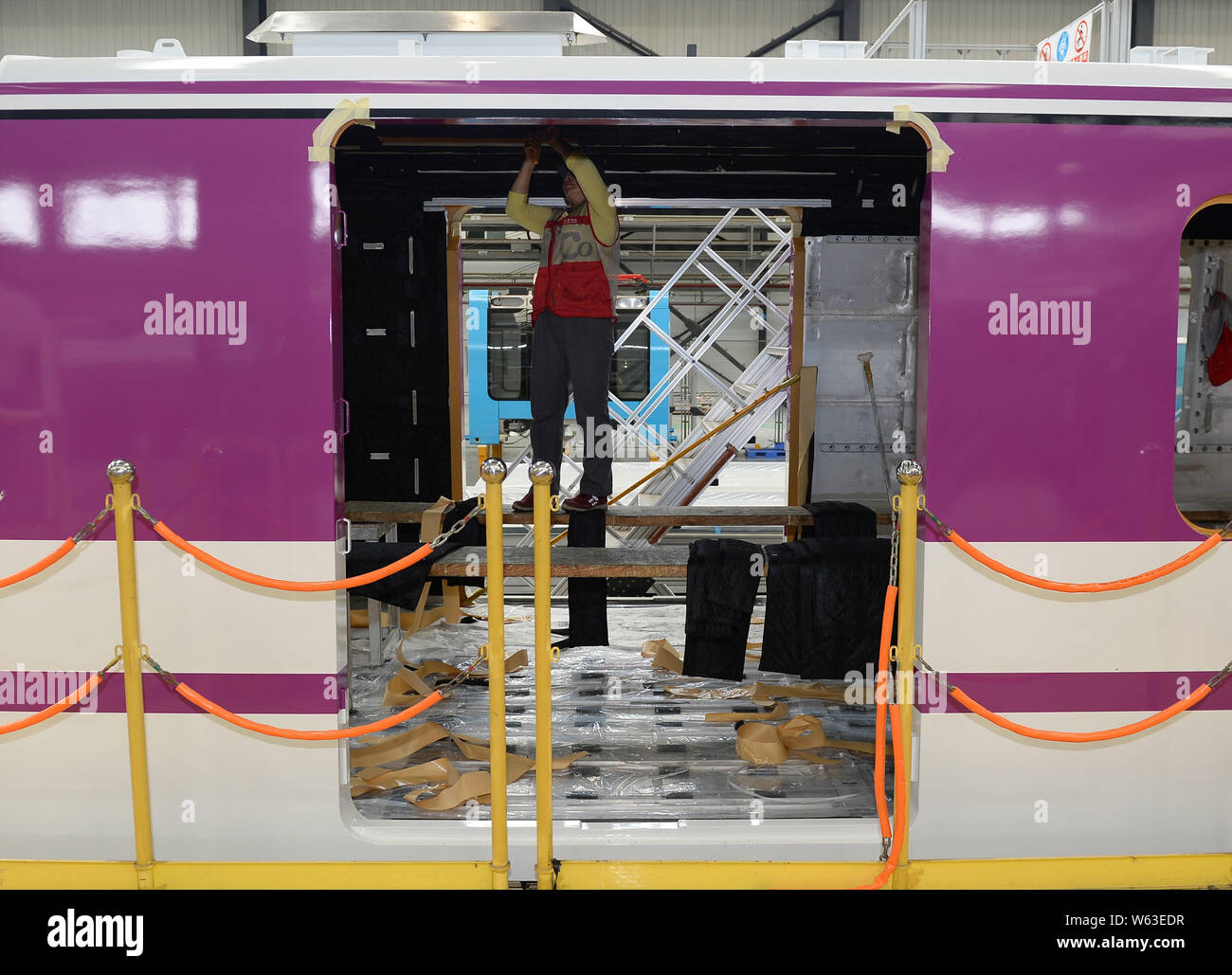 Ein chinesischer Arbeiter prüft ein chengdu U-Bahn Linie 5 mit Gesichts Make-up-Zug in Sichuan Oper als seine vorderen Aussehen in Chengdu City, im Südwesten Chinas Stockfoto