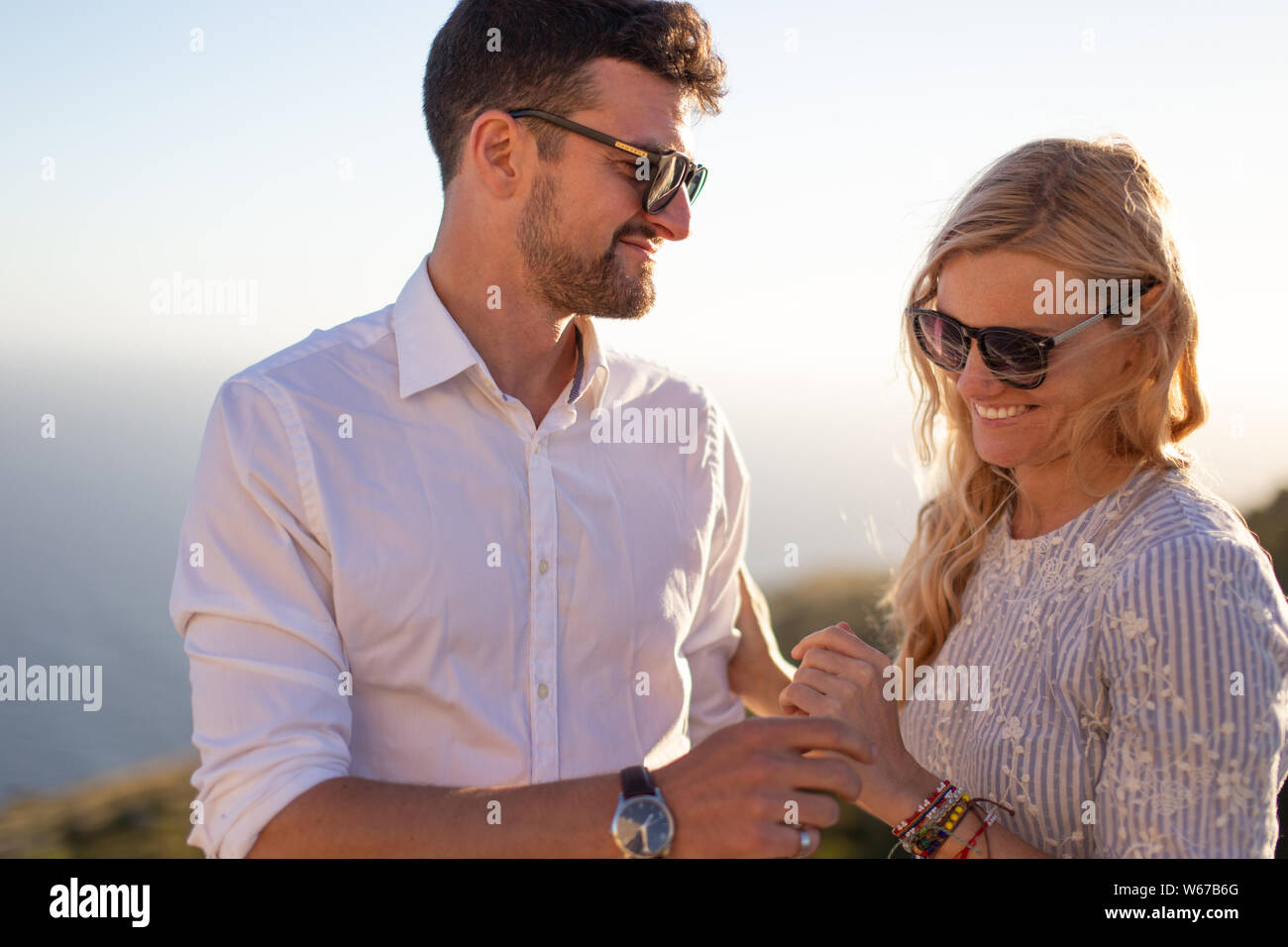 Glückliches junges Paar in Liebe im Sonnenuntergang Lächeln, genießen Sie Momente zusammen Stockfoto