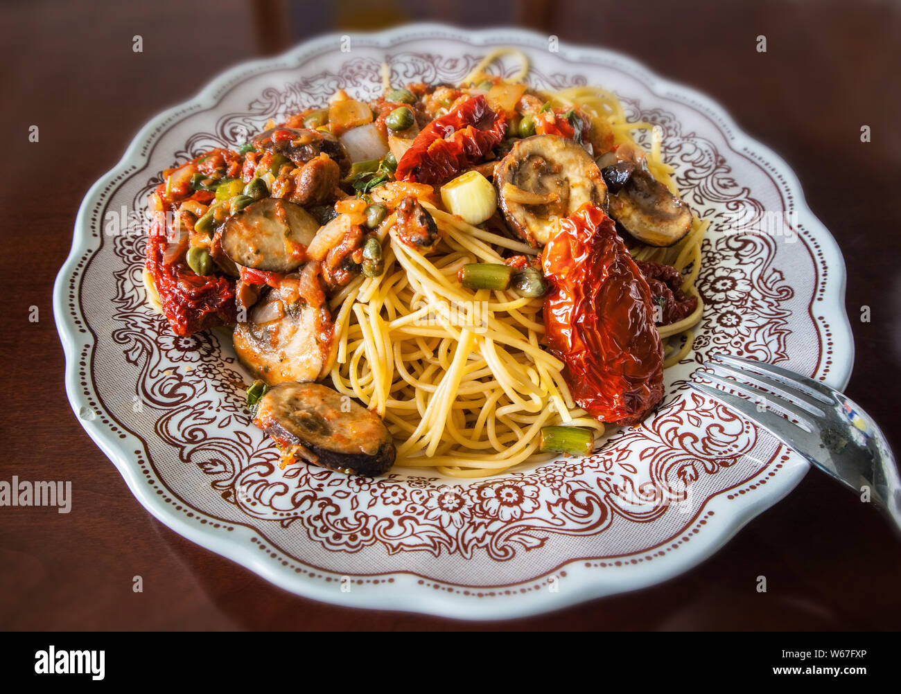 Eine mediterrane Pasta essen in einem dekorierten Teller Stockfoto