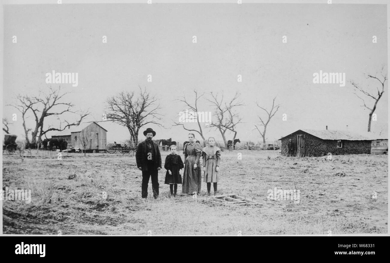 Aufenthalt von G. L. in der Regel Feb 18, 1898. Hier haben seit Sept. 1893 lebte. Familie steht im Vordergrund; sod Gebäude und Kabine im Hintergrund, Arizona Territory Stockfoto