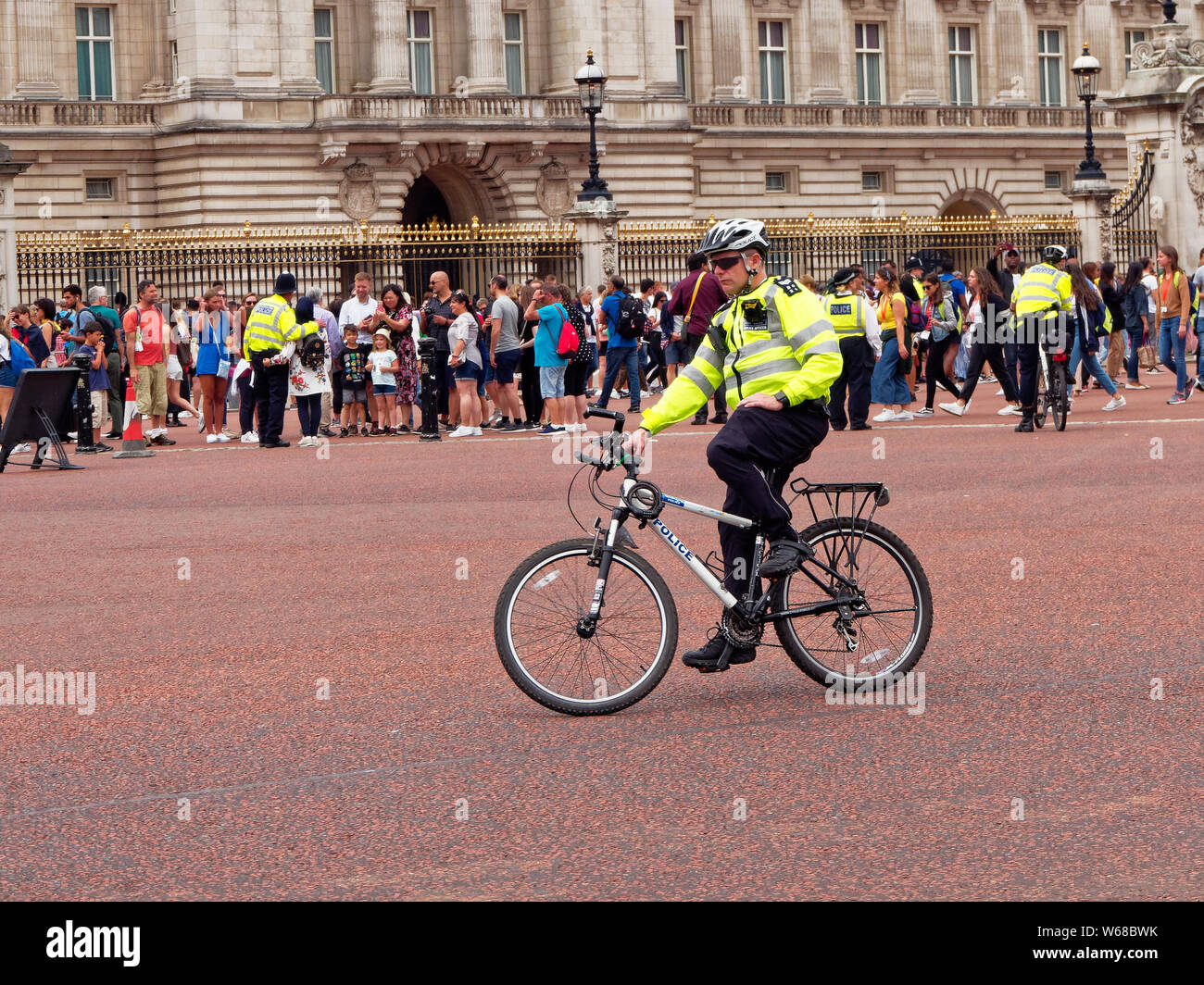 Ein Polizist auf einem Fahrrad auf Aufgabe außerhalb der Buckingham Palace in London, England Stockfoto