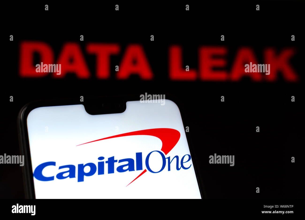 Capital One Bank Logo auf dem Smartphone und roten Warnmeldungen Worte DATEN Leck im verschwommenen Hintergrund. Konzeptionelle Foto für die Verletzung. Stockfoto
