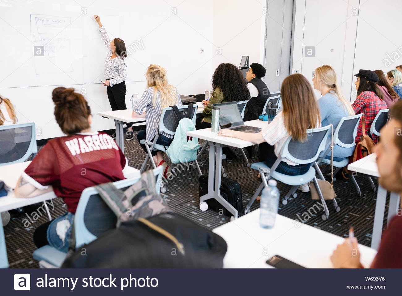 Lehrbeauftragte Studenten und Schreiben auf dem Whiteboard Stockfoto